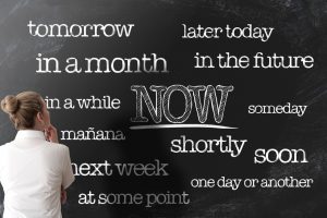get things done or start doing things now anti procrastination concept on blackboard